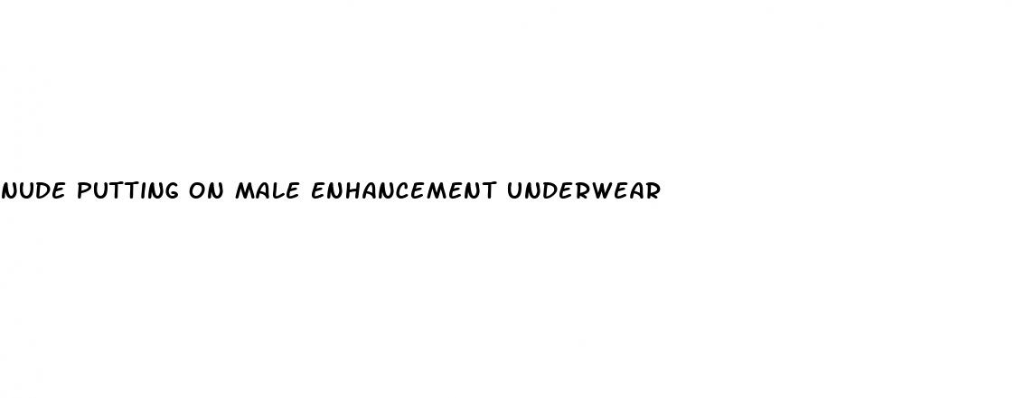 nude putting on male enhancement underwear