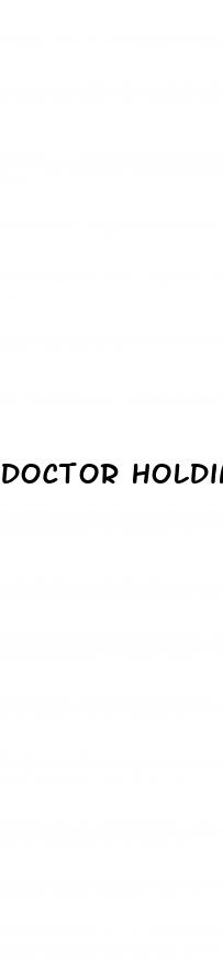 doctor holding shockwave gun for erectile dysfunction